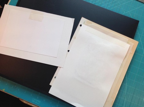 This shows how the tape is attached. The one on the left has the plate on top of the paper because it is smaller; the one on the right has the plate on the bottom because it is larger (and heavier, with the cardboard photo album page) then the paper. When they are open you just turn them so that you can work on the plate, so it doesn't really matter which one is on top.