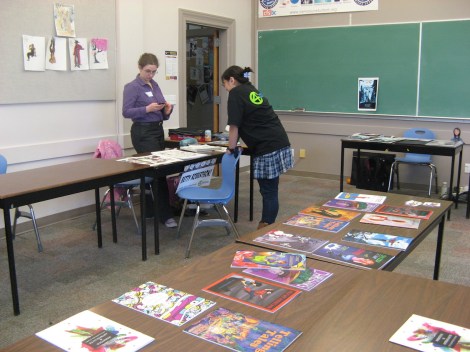 Two of my friends chat in the background while our comics from last year repose in glory on the central table.