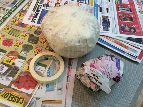 The first thing to do was to wad up bunches of paper into balls for the body and head. The body is about the size of a slightly flattened cantaloupe. I got a little carried away with the tape; it didn't need to be this thorough. 