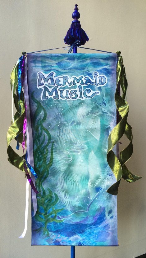 I made this banner from things I had lying around — an old pole from when I used to sell tassels at markets, and an unfinished canvas painting which converted to the purpose with markers. Everyone thought it was one of the expensive, commercially printed ones!